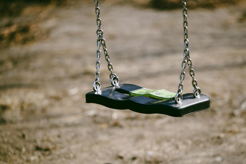 Empty playground swing symbolising emotional highs and lows experienced in bipolar disorder