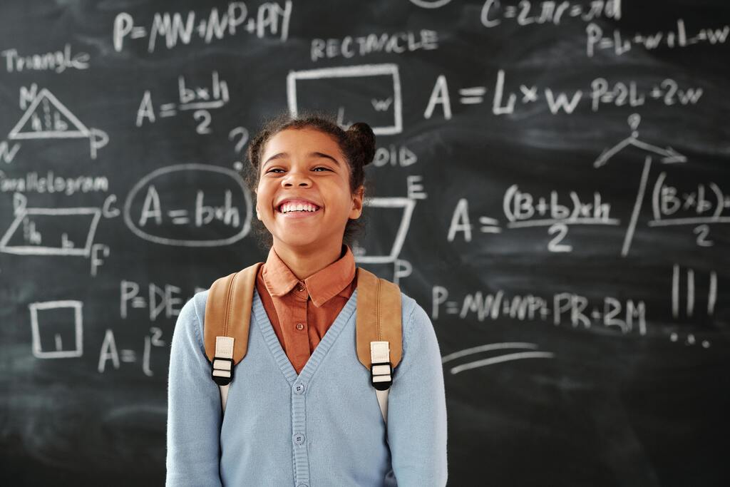 Student standing confidently in front of a classroom board during subject choice and vocational assessment